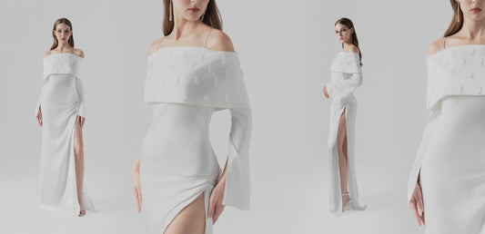 The white silk maxi dress , crafted with off-shoulder design, crystal embellishments, and a high side slit.