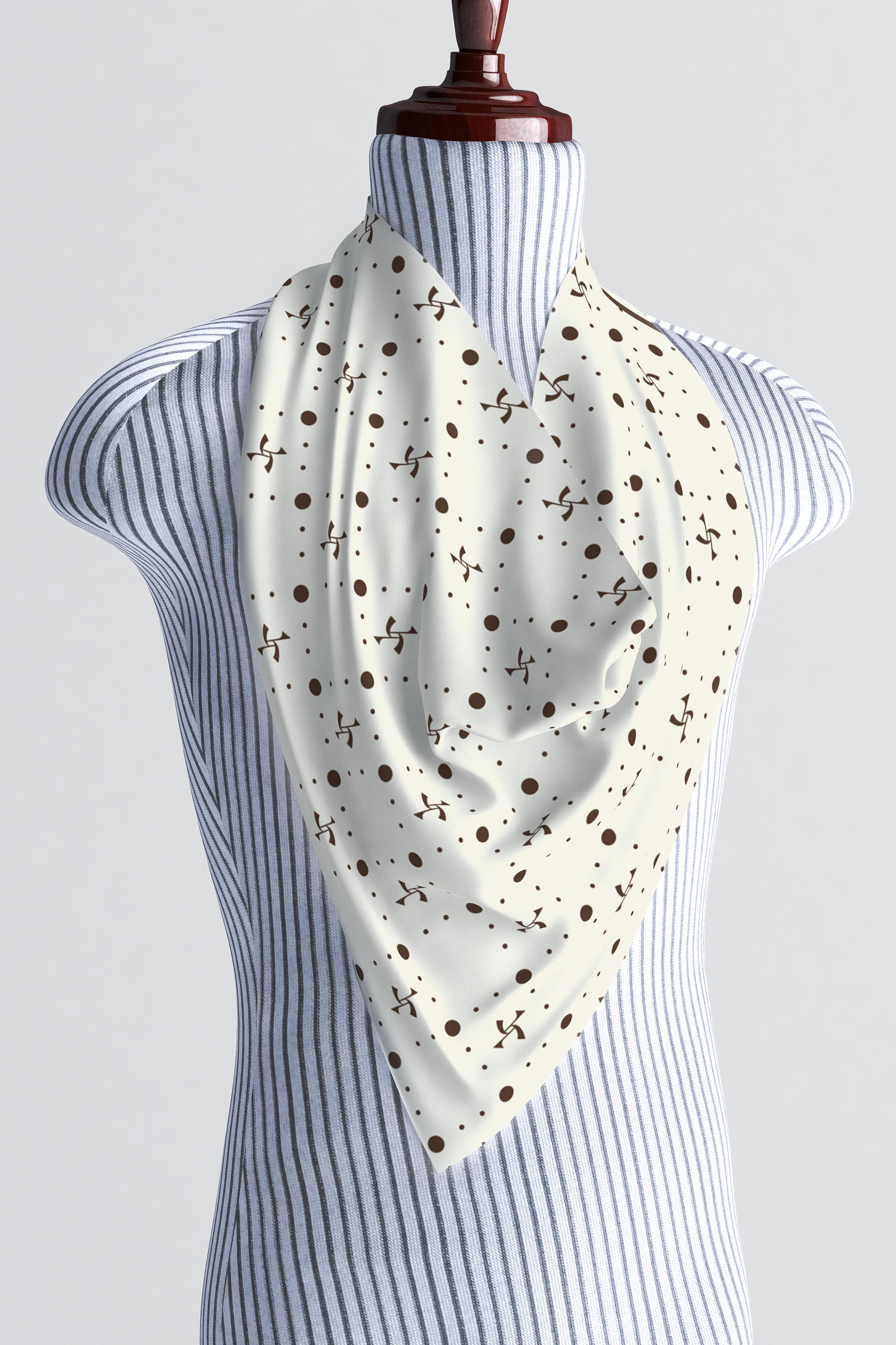 Beige silk scarf with a brown vintage pattern tied around the neck