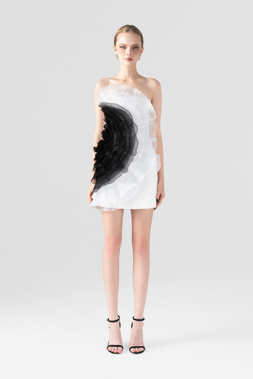 The White Ruffle Mini Dress with an asymmetrical one-shoulder design and black organza ruffles.