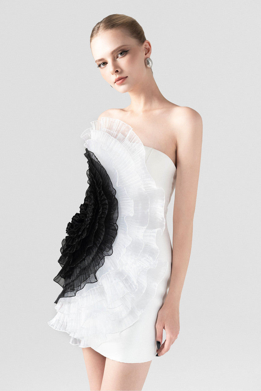 The White Ruffle Mini Dress with an asymmetrical one-shoulder design and black organza ruffles.