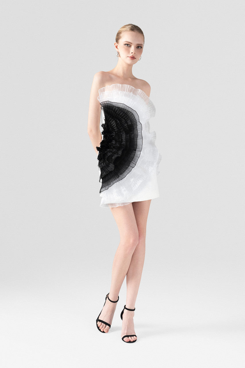 The White Ruffle Mini Dress with an asymmetrical one-shoulder design and black organza ruffles.