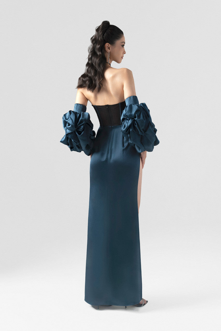 A navy blue silk dress, featuring a structured black mesh corset, detachable puffed sleeves, and a striking high slit.