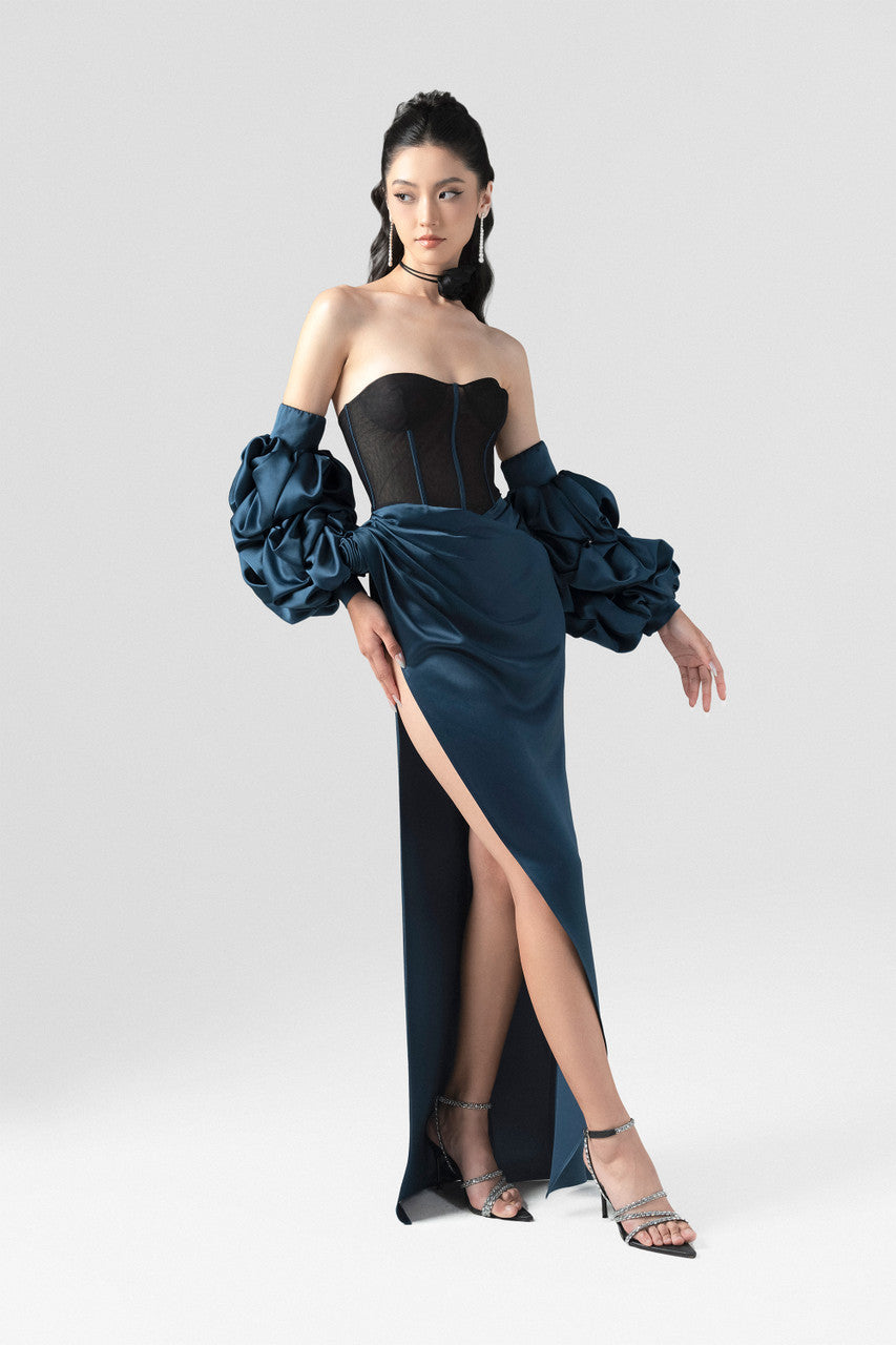 A navy blue silk dress, featuring a structured black mesh corset, detachable puffed sleeves, and a striking high slit.
