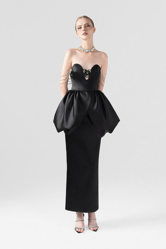 Black silk maxi dress, with a puffy waist and wavy neckline.