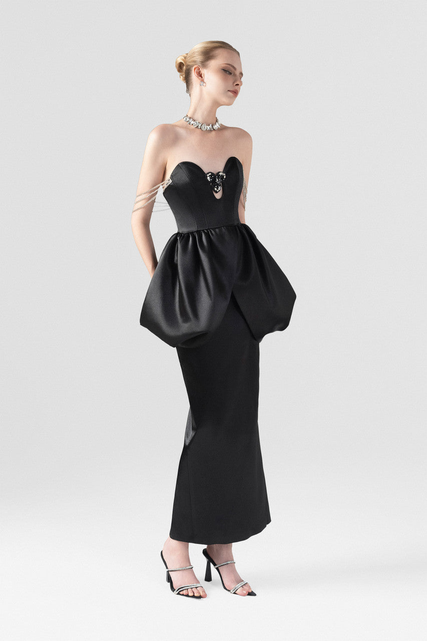 Black silk maxi dress, with a puffy waist and wavy neckline.
