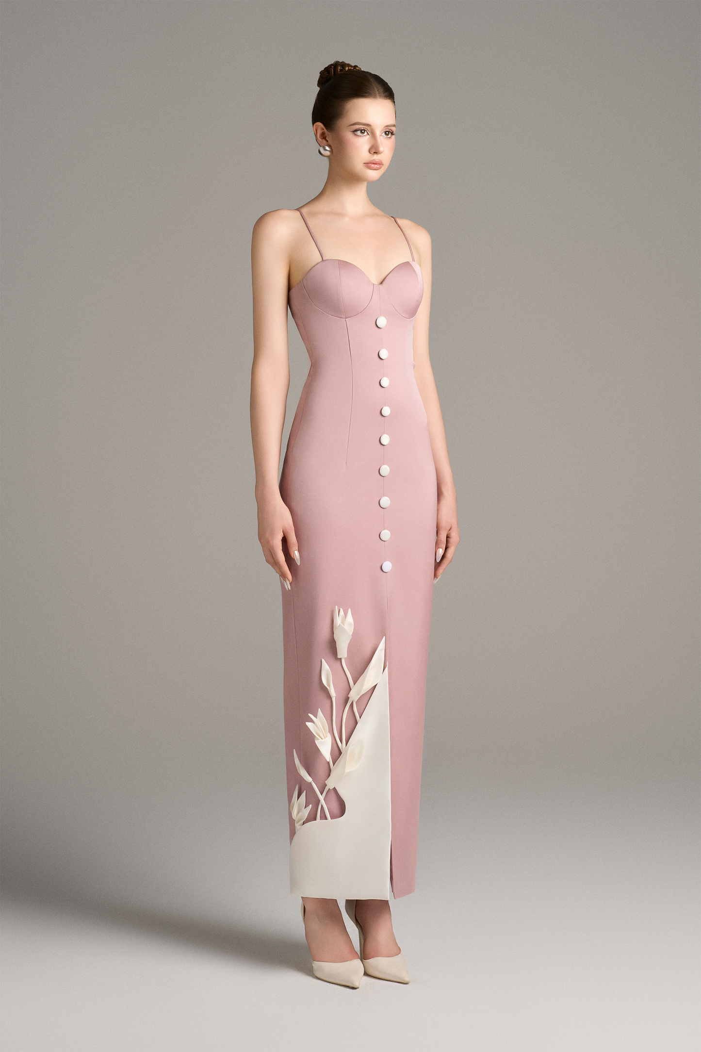 Model wearing a pink dress with white floral design