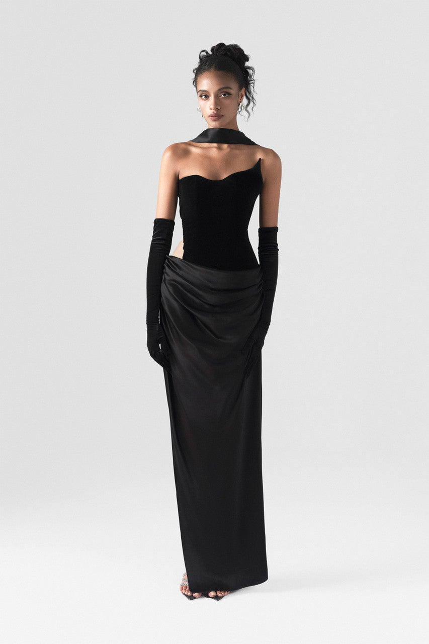 The black maxi dress, combining two premium fabrics: velvet and silk, featuring a matching silk scarf and gloves.