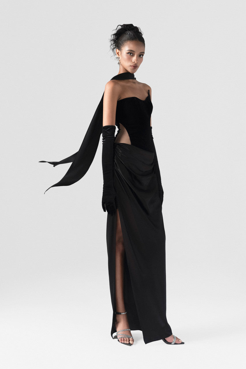 The black maxi dress, combining two premium fabrics: velvet and silk, featuring a matching silk scarf and gloves.