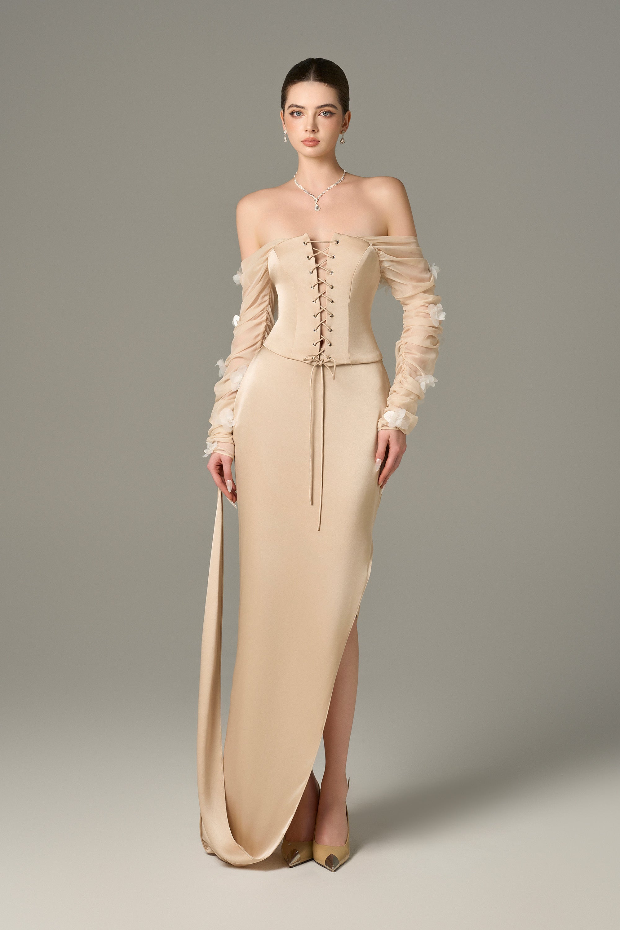 The Cream Chiffon Silk Corset and Maxi Set feature a lace-up corset and ruffle floral sleeves.