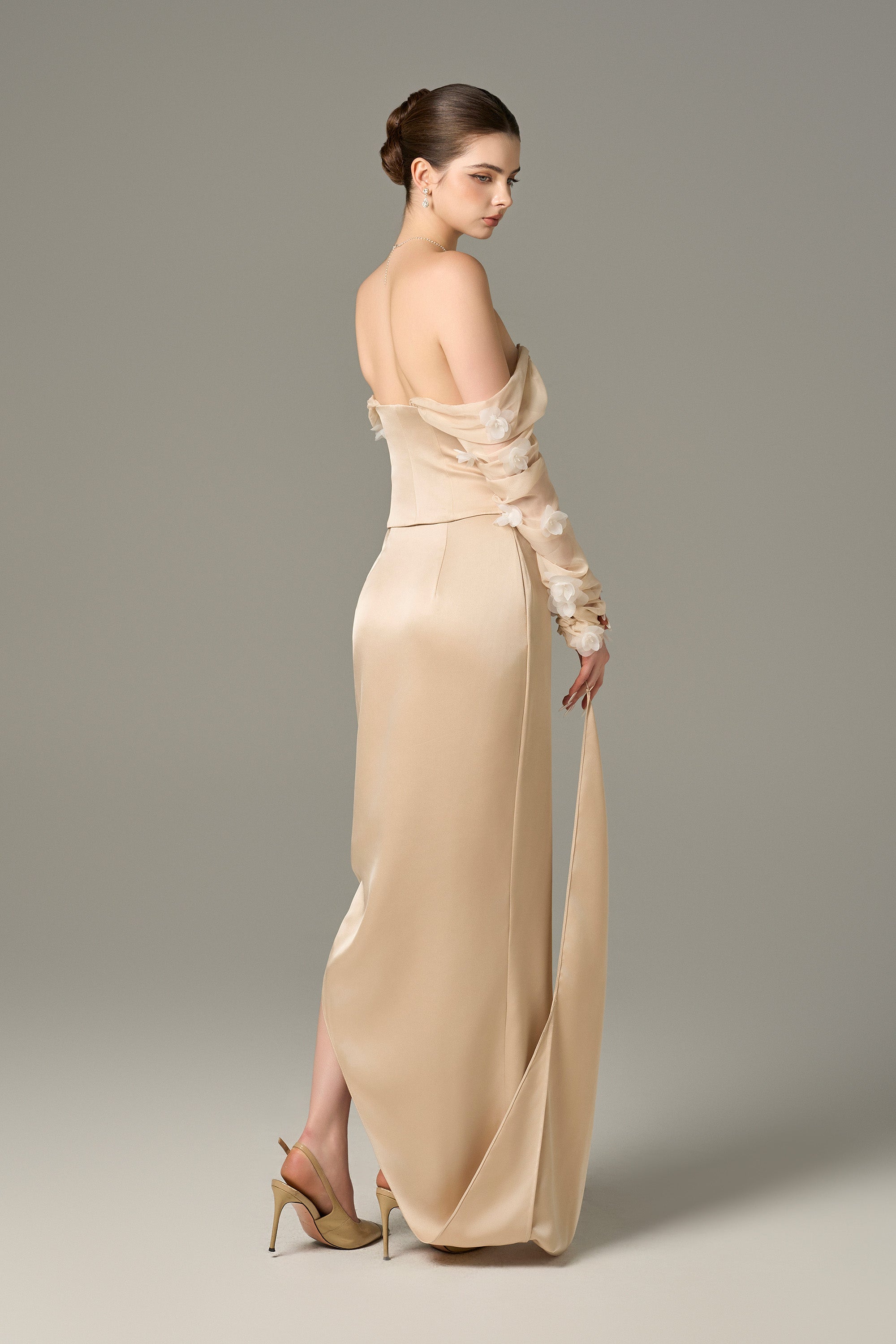 The Cream Chiffon Silk Corset and Maxi Set feature a lace-up corset and ruffle floral sleeves.