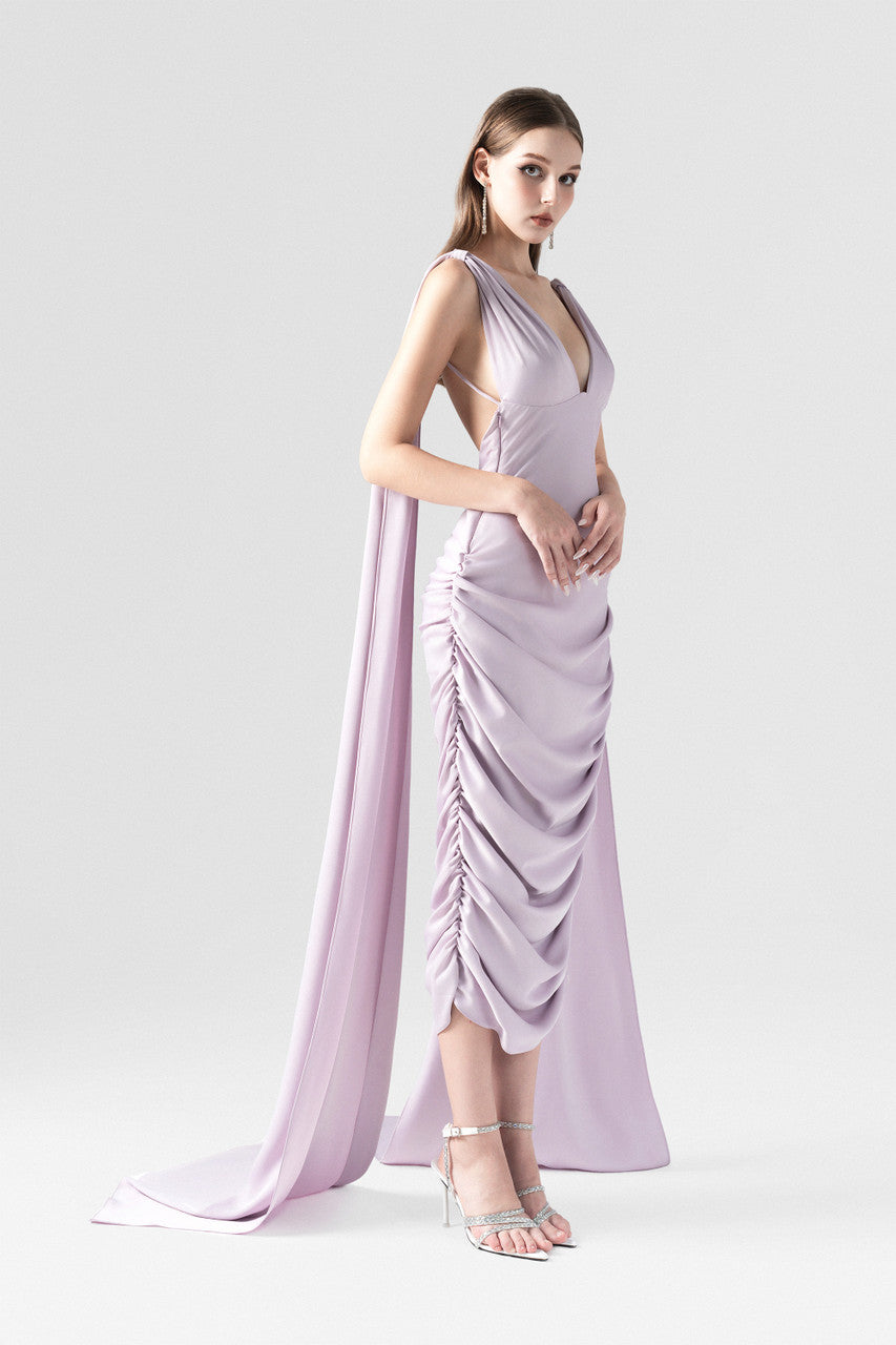 A purple silk dress with V-neckline and two flowing silk flaps.