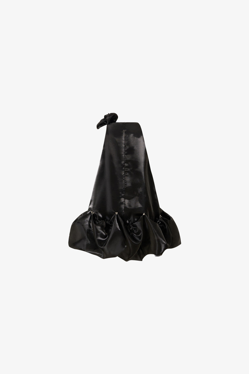 The black mini dress, featuring a oversized floral accent at the neckline and a bubble hem.