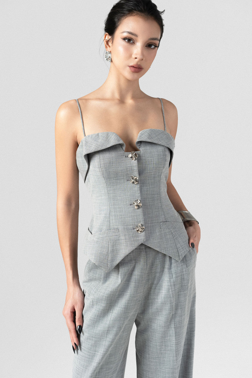 A grey tweed set, featuring a sleeveless waistcoat top with thin spaghetti straps, and long, straight-leg pants.