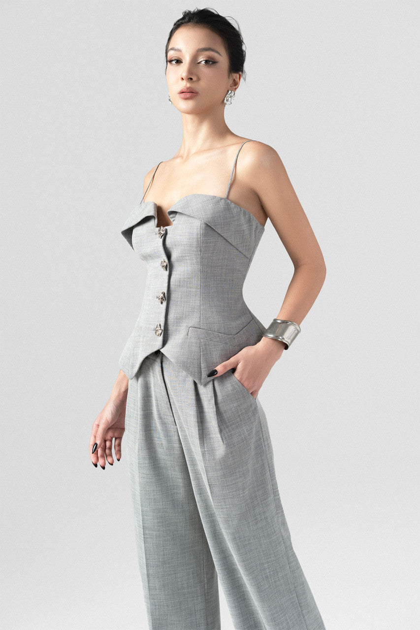 A grey tweed set, featuring a sleeveless waistcoat top with thin spaghetti straps, and long, straight-leg pants.