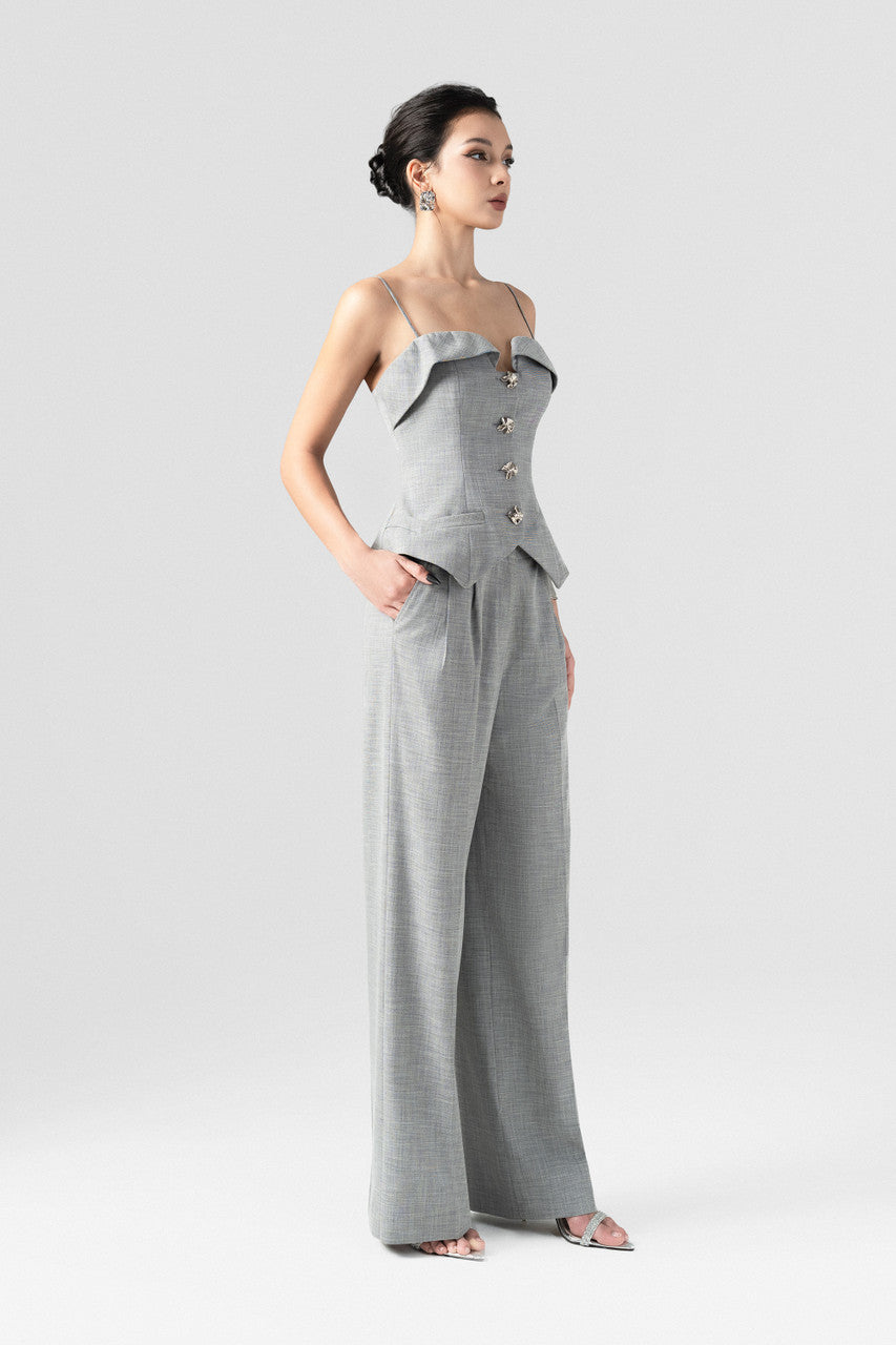 A grey tweed set, featuring a sleeveless waistcoat top with thin spaghetti straps, and long, straight-leg pants.