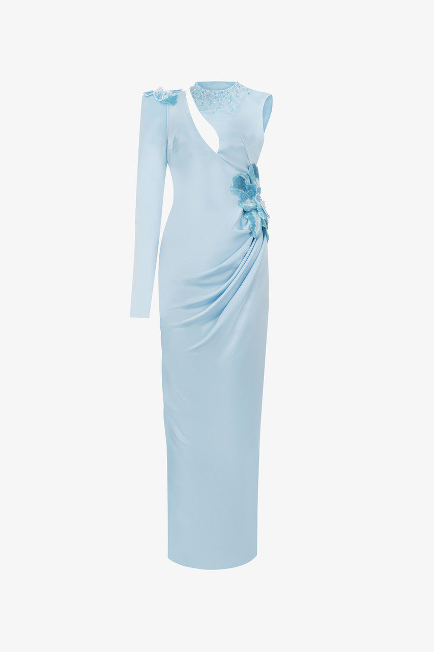 A blue silk maxi dress, with sequin floral accents and asymmetrical design.