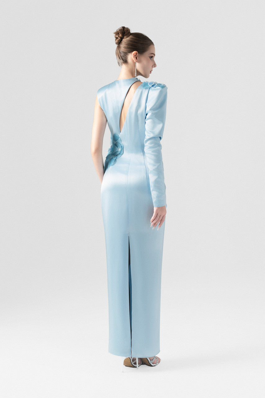 A blue silk maxi dress, with sequin floral accents and asymmetrical design.