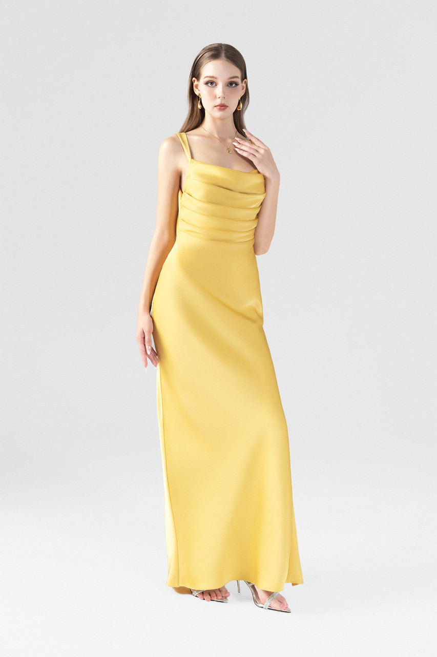The gold yellow maxi dress, featured cowl neckline with pleats, a side slit and back cutouts.