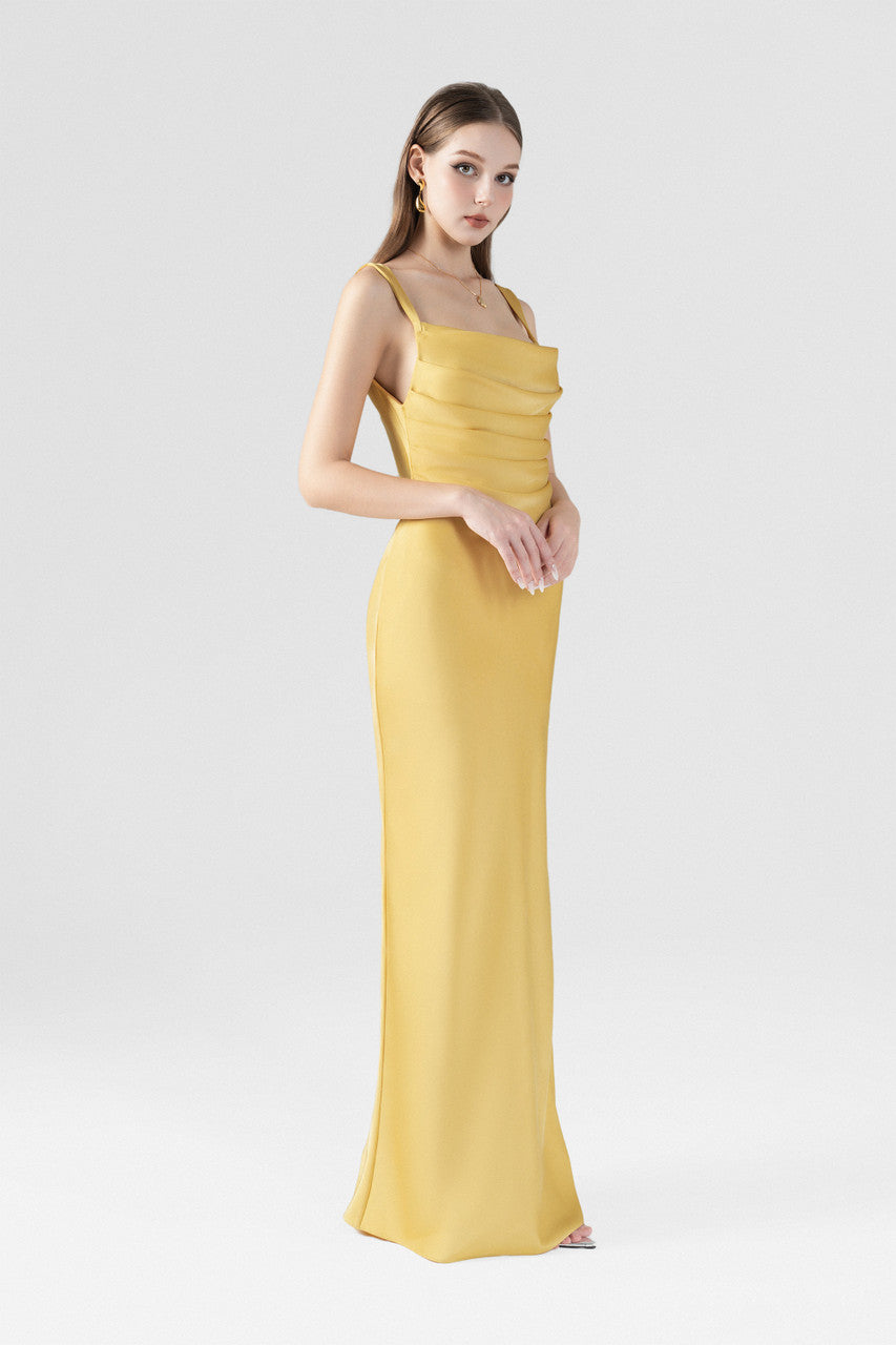 The gold yellow maxi dress, featured cowl neckline with pleats, a side slit and back cutouts.