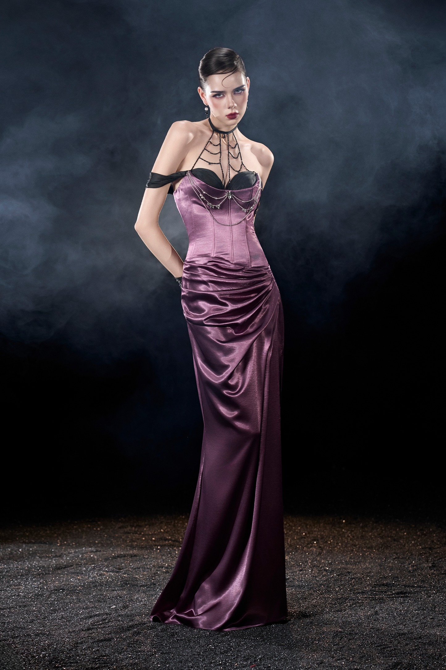 Model wearing a long, elegant purple dress