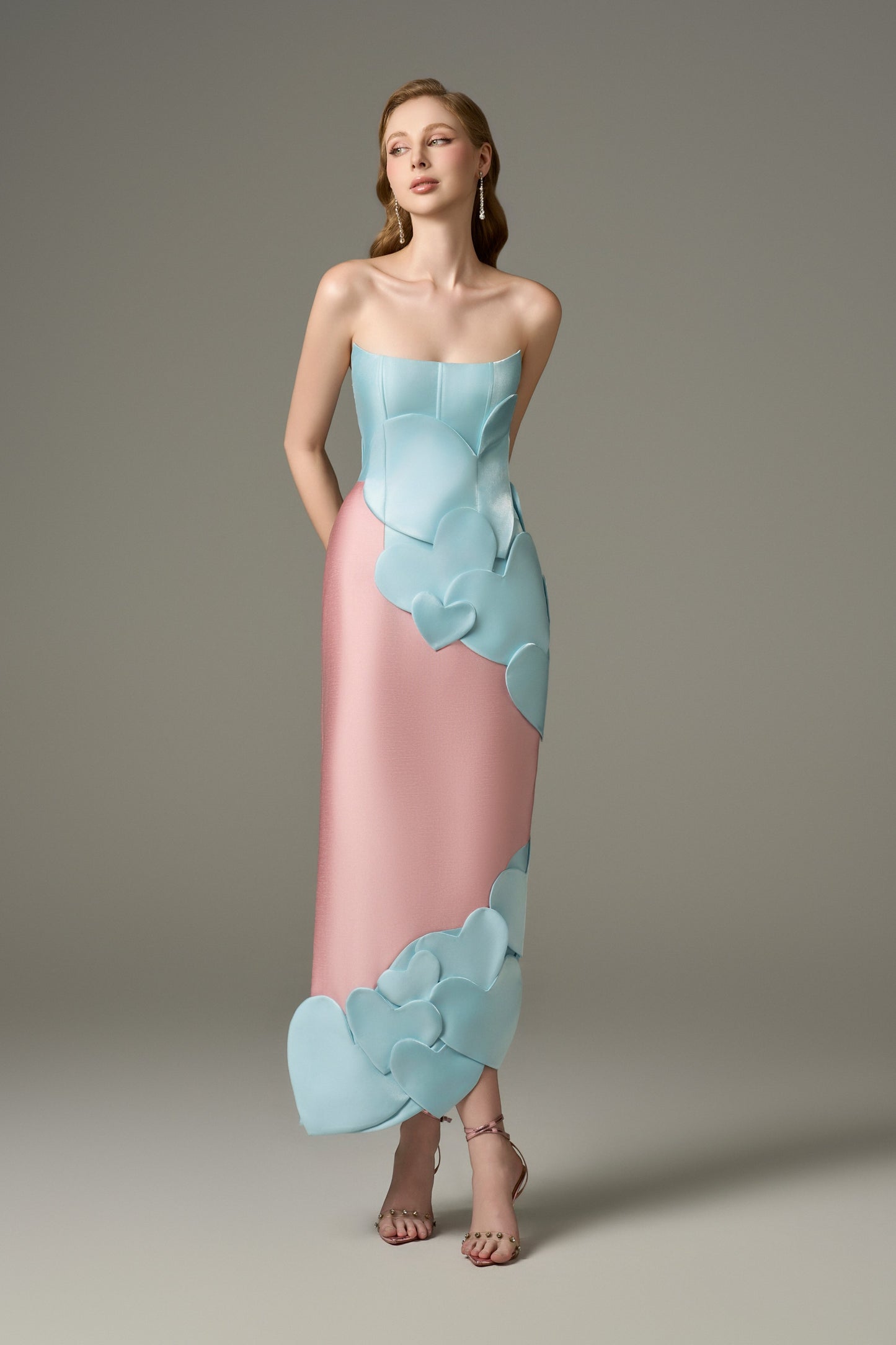 A full-length font view of a Darling color mix taffeta maxi dress, showcasing its bodycon fit and the fluid movement of the asymmetric skirt.