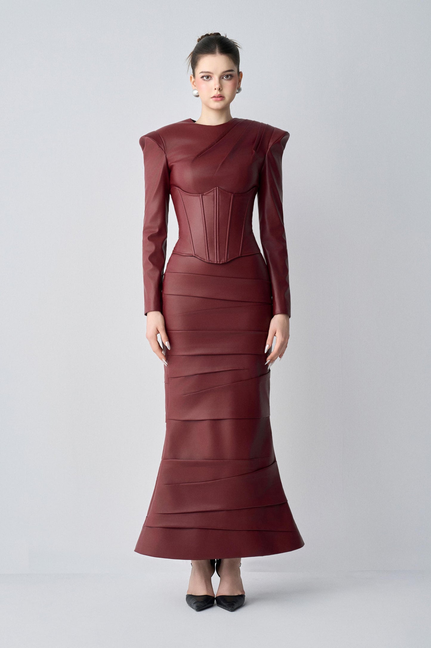 Maroon dress worn by a model on a light gray background