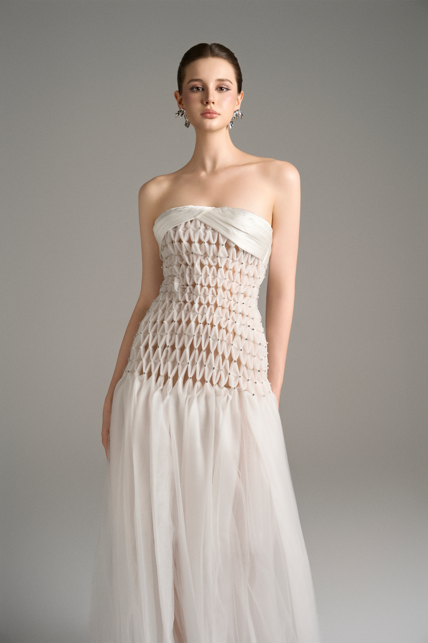 Close-up of strapless maxi dress with nude-lined criss-cross bodice and drop waist design