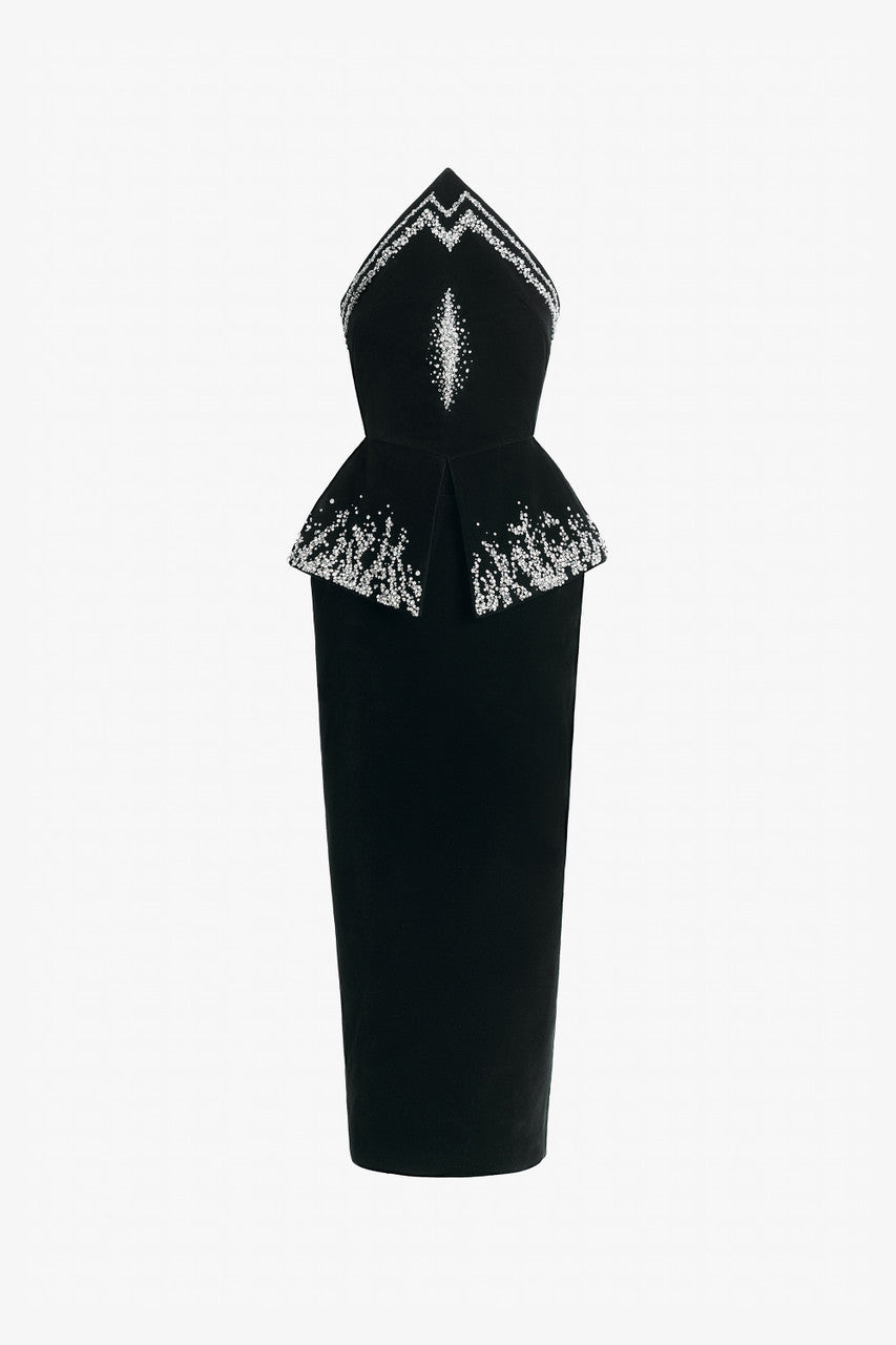 Black evening dress in velvet with a peplum and form-fitting skirt.