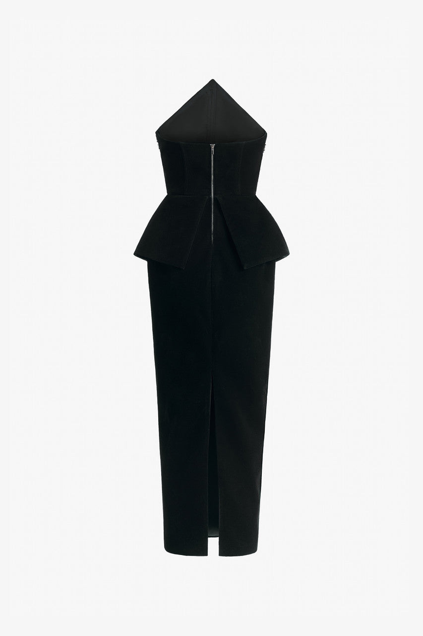 Black evening dress in velvet with a peplum and form-fitting skirt.