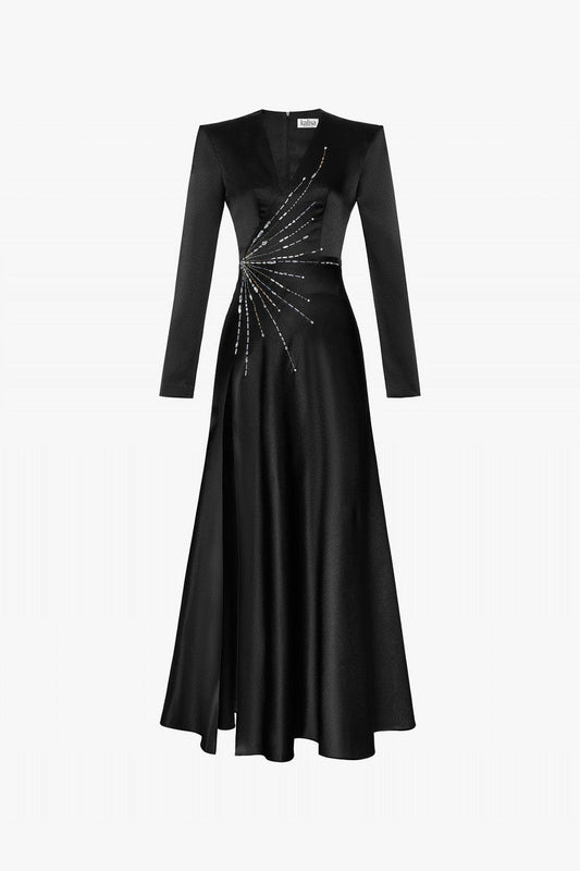 A black silk gown with handcrafted bead embellishments and a high-thigh slit.