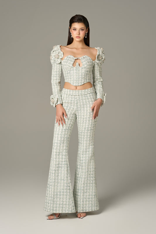 a set in mint green tweed, with a crop top and high-waisted flared trousers.