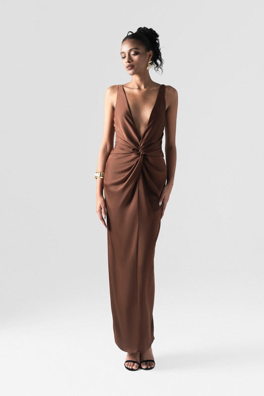 The brown silk maxi dress detailed with a deep V-neck and innovative 3D twist at the waist.