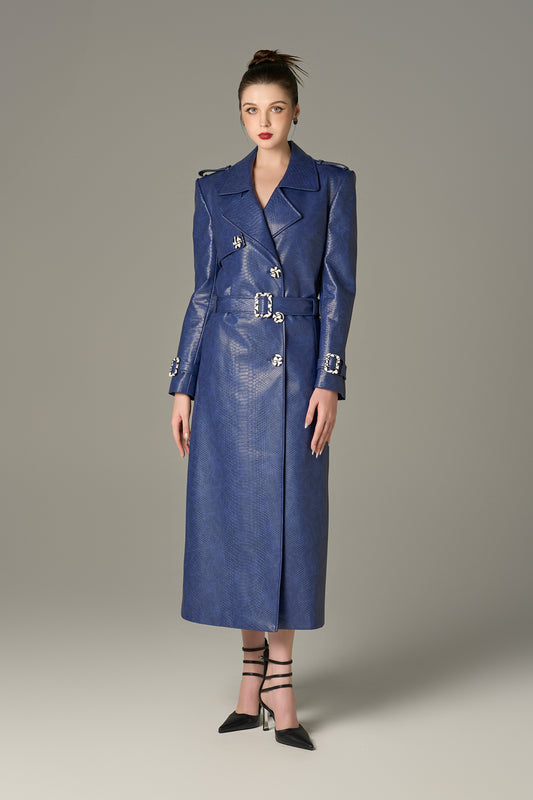 A long coat in navy crocodile-patterned leather, featuring a belt.