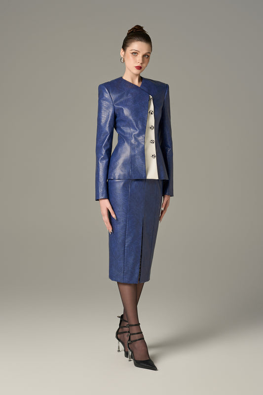 A navy set in crocodile-patterned leather, featuring a structured jacket and a pencil skirt.