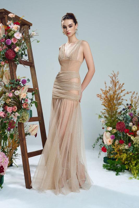 the beige evening dress in shimmering fabric, featuring a sheer, flowing skirt, cut-outs.