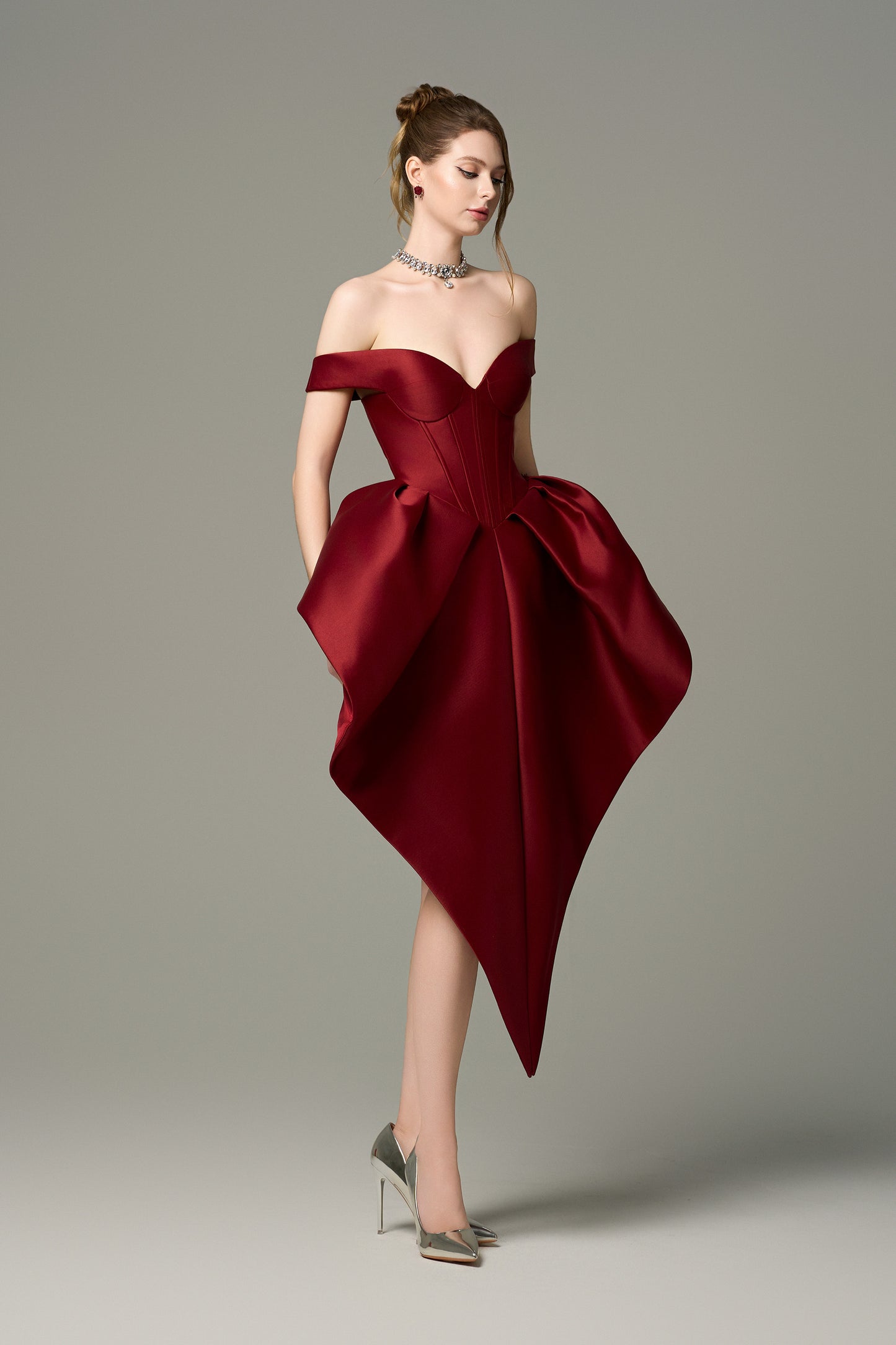 Off-the-shoulder sweetheart mini dress with structured bodice and skirt in deep red.