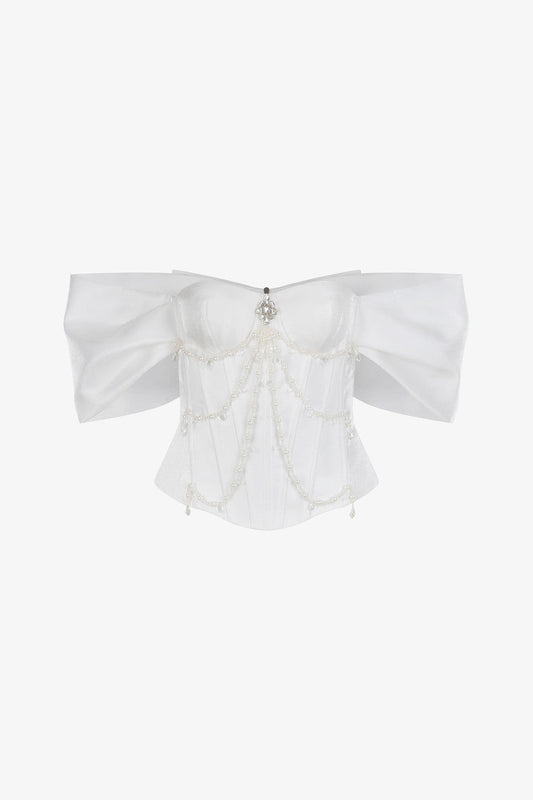 The white organza set, featuring an off-shoulder corset top and a asymmetrical silk skirt with diagonal cut.