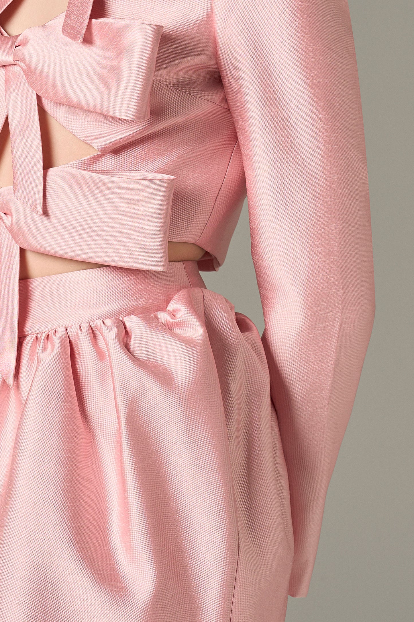 The Pink Cutout Tiered Mini Dress with oversized bows, chic cutouts, and a voluminous skirt.