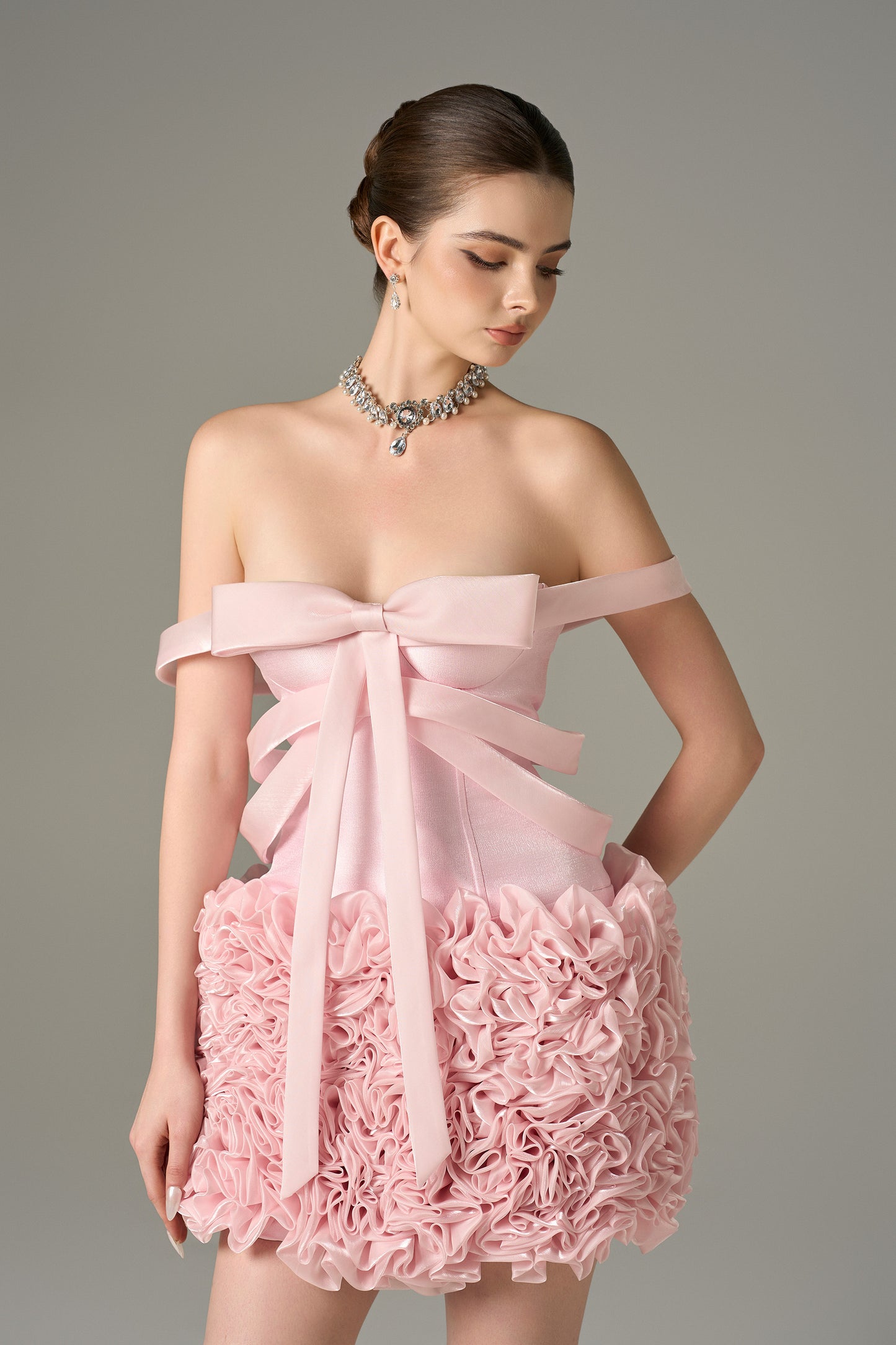 The Pink Floral Embellished Mini Dress features bow strap on bust and hand-sewn floral details.