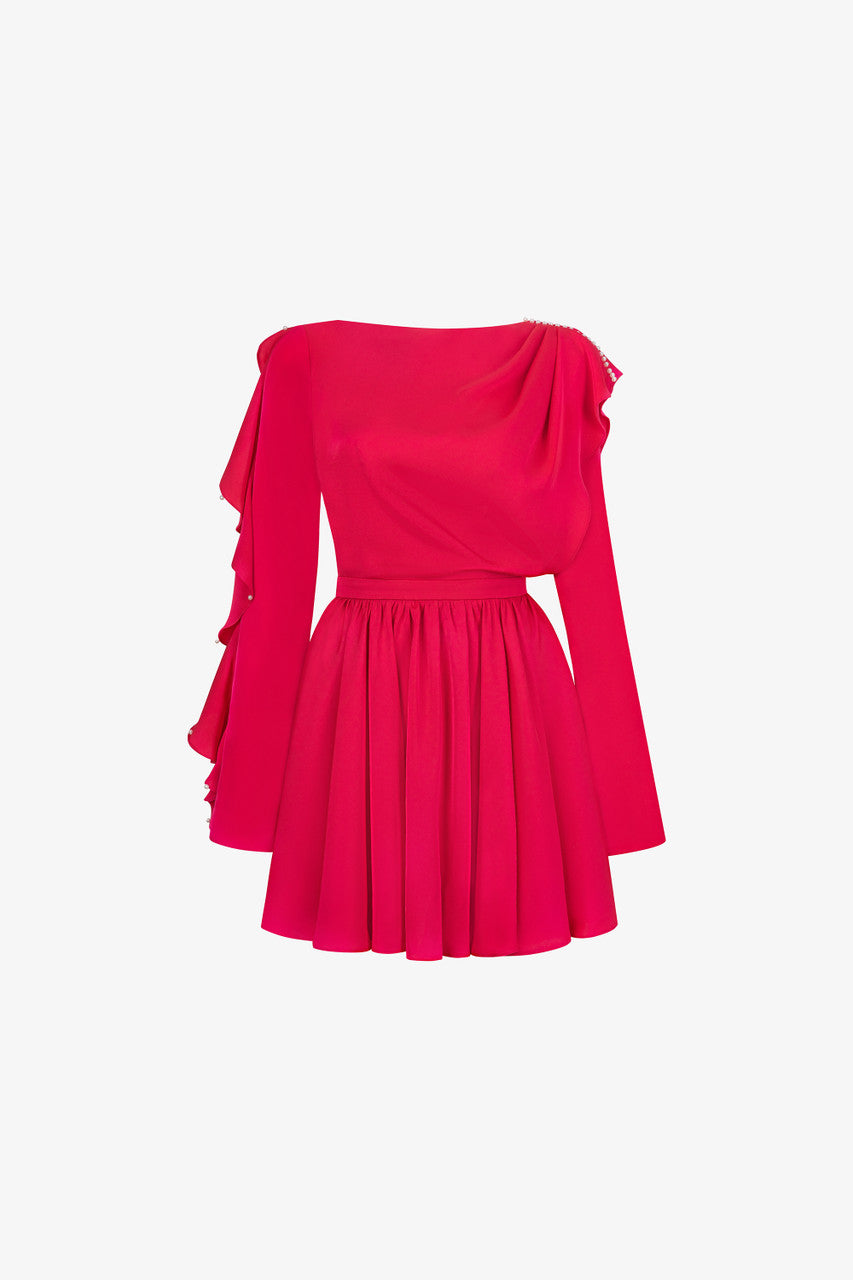 The pink silk mini dress, featuring daring open-back design, flowing pleats and ruffled detailing.