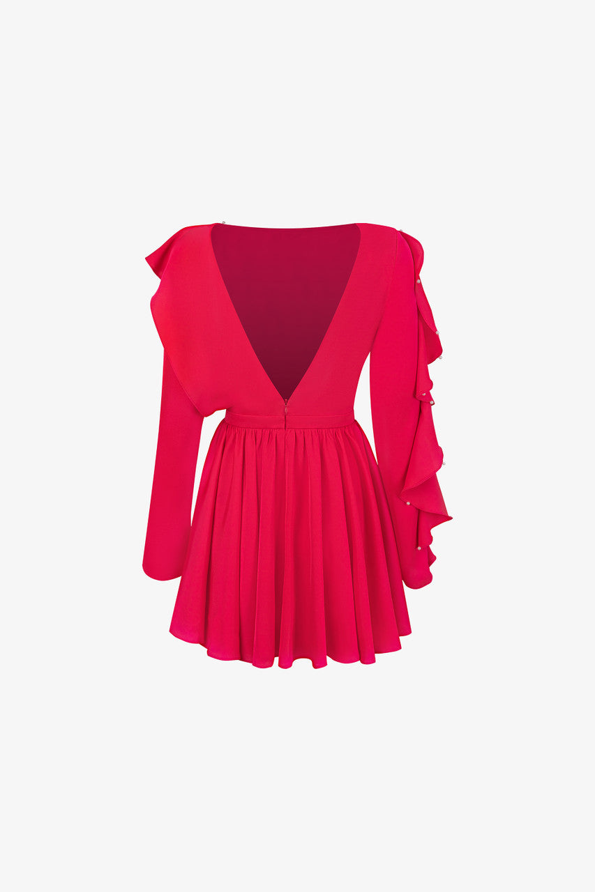 The pink silk mini dress, featuring daring open-back design, flowing pleats and ruffled detailing.