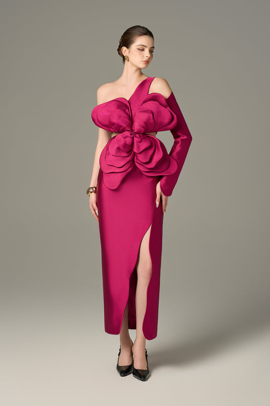 Pink Maxi Dress features an asymmetrical one-sleeve design with layered floral details and a thigh-high slit.