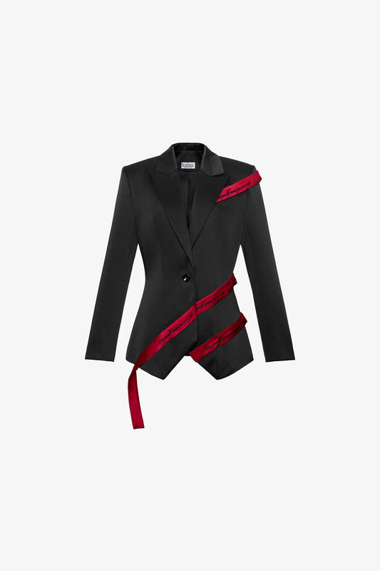 The black blazer in taffeta, featuring diagonal flaps, structured padded shoulders, and red straps