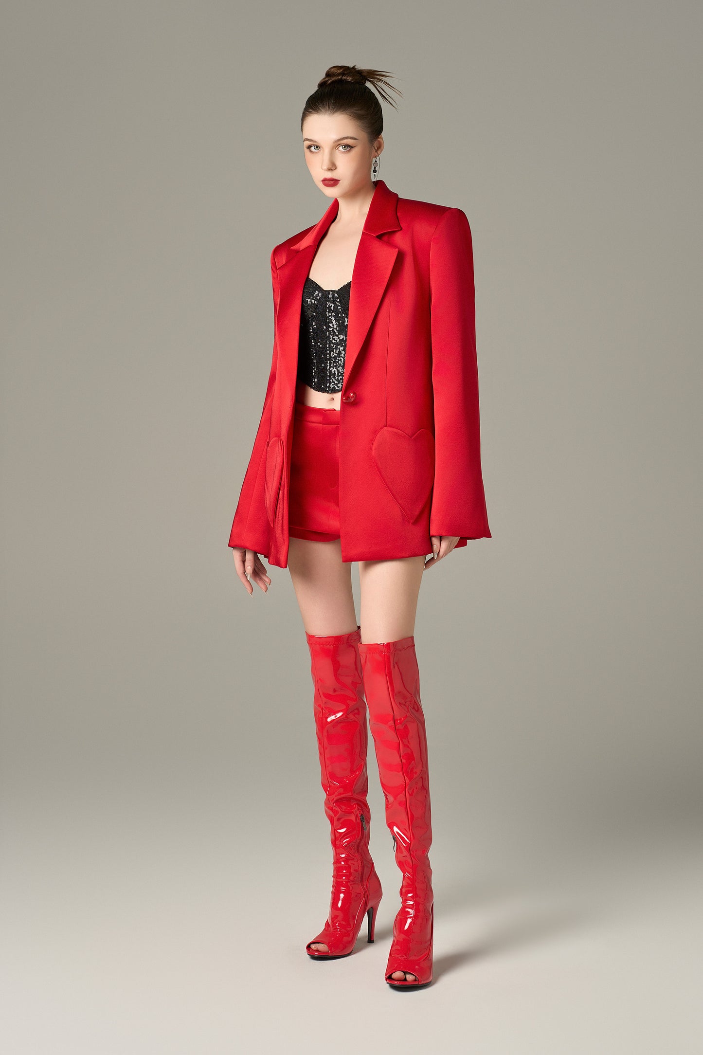 a red blazer in taffeta with a relaxed fi, heart-shaped pockets, and a heart-shaped cut-out at the back.
