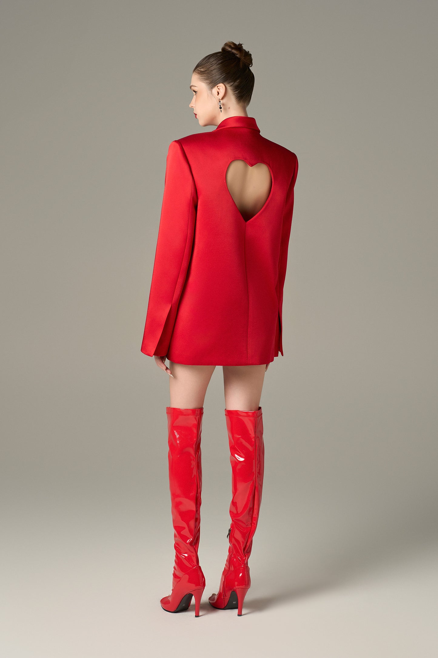 a red blazer in taffeta with a relaxed fi, heart-shaped pockets, and a heart-shaped cut-out at the back.