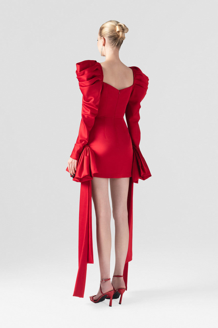 The red silk mini dress, with bust cup bodice, puffed sleeves and two crafted bows at the hips.