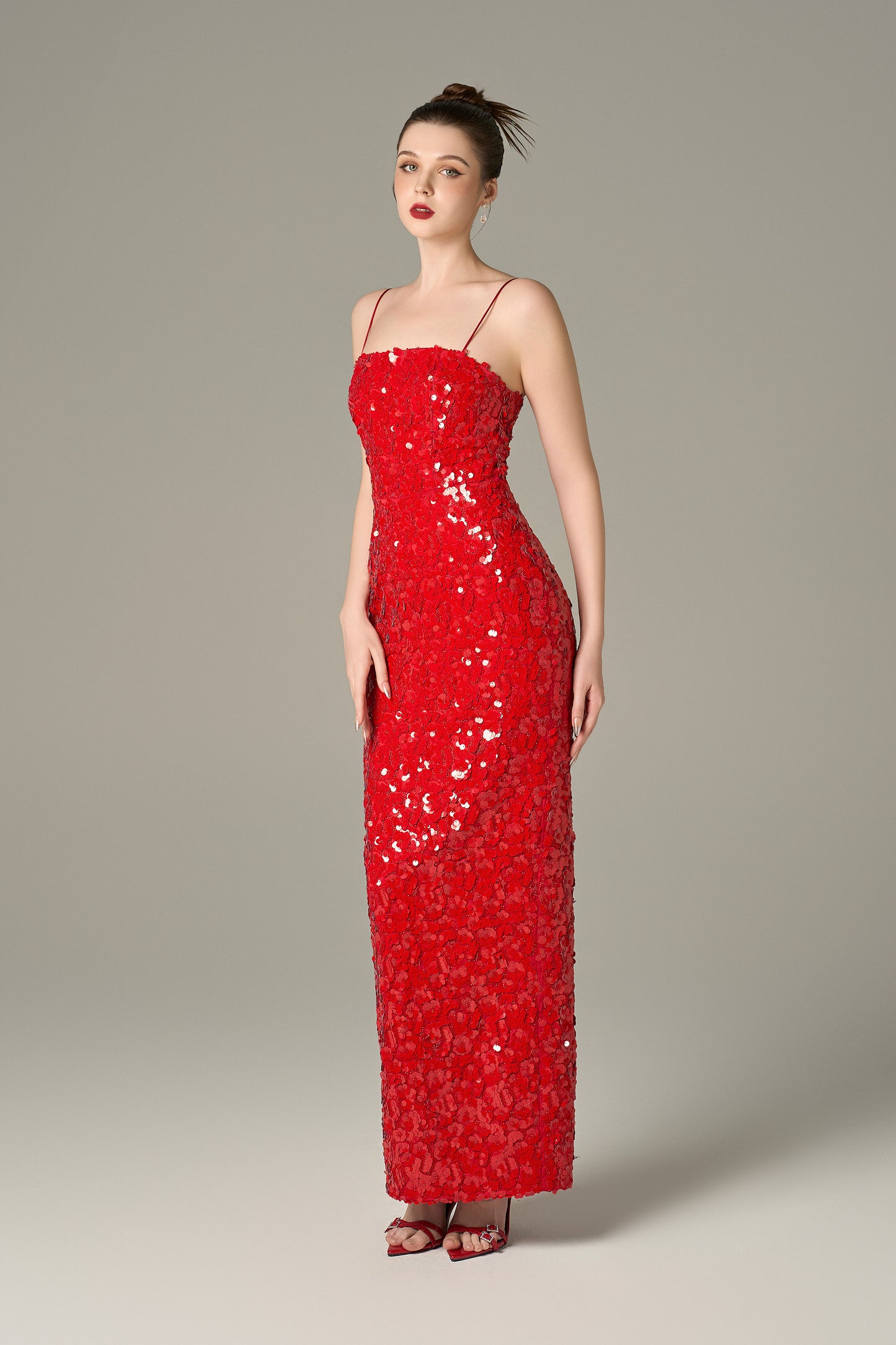 The Red Sequin Maxi Dress stuns with shimmering sequins and feathered shoulders.