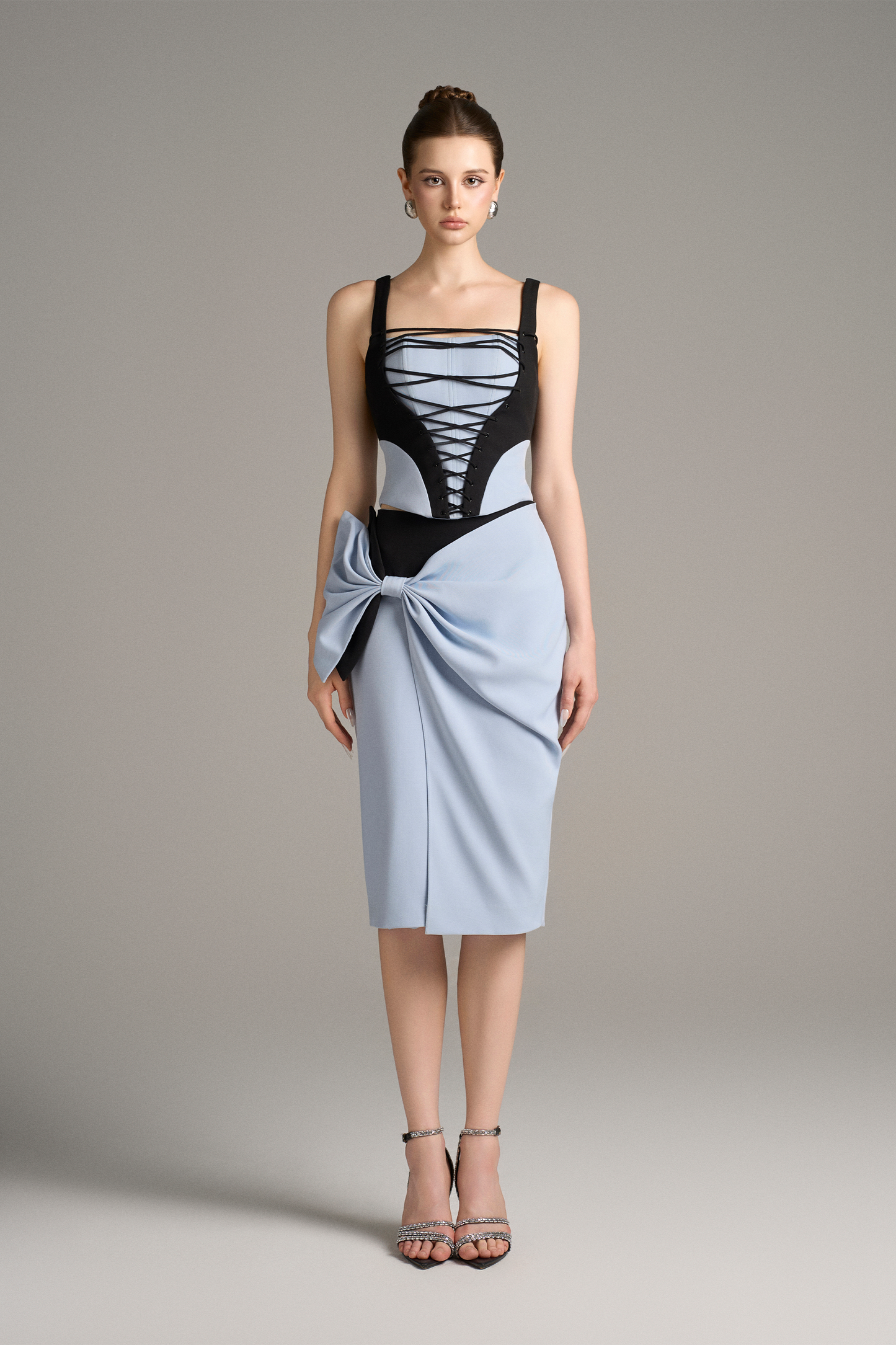 Woman wearing a black and blue top with a blue skirt