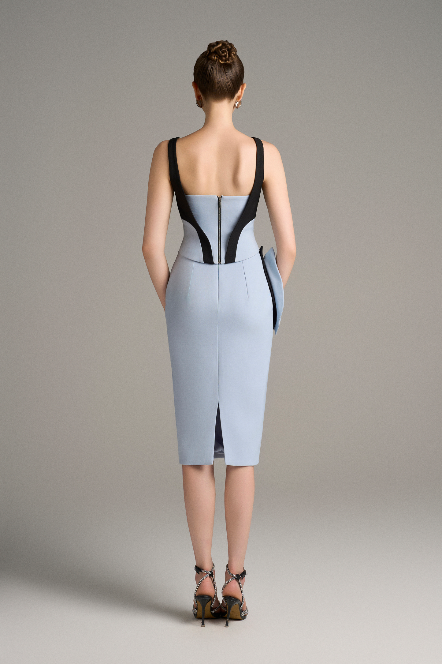 Woman wearing a blue dress with black accents