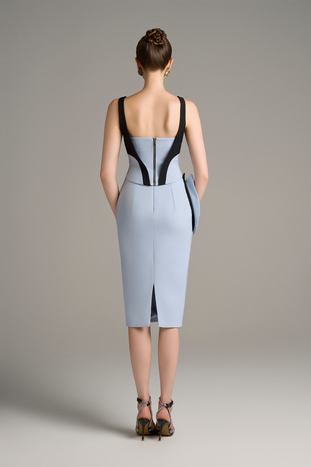 Woman wearing a blue dress with black accents